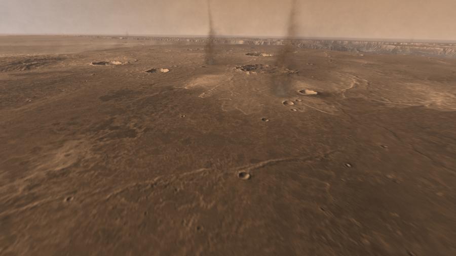 Пылевые вихри на Марсе. Вдали видна долина Маринер.