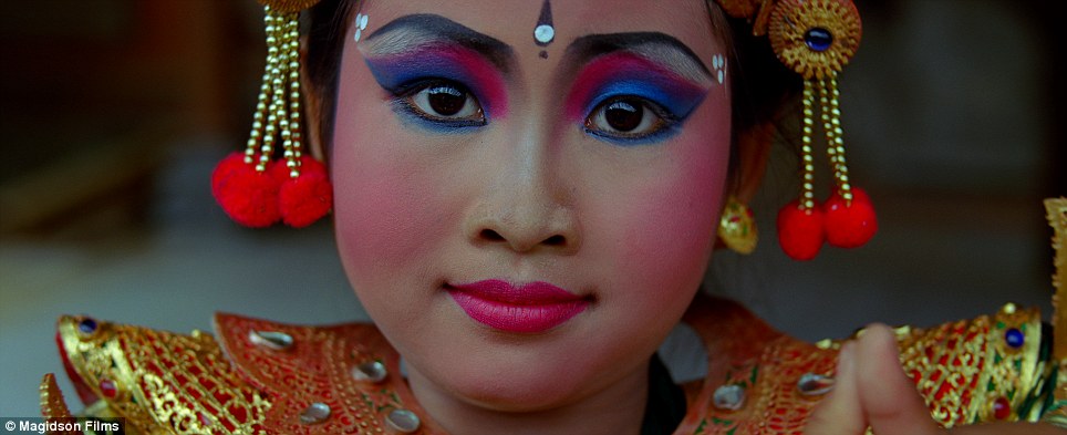 Ornate: The makeup includes heavily-penciled brows and vivid eyeshadow in pink and blue