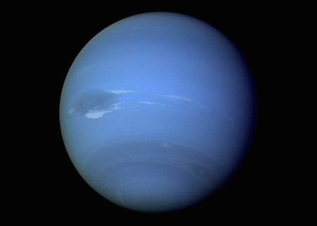 A photo of a full side of Neptune, showing a light blue color and dark bands near the southern pole.