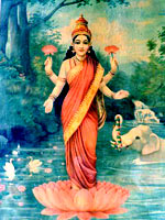 The goddess Lakshmi in a red sari, standing on a lotus flower on a lake, being anointed with water by a white elephant
