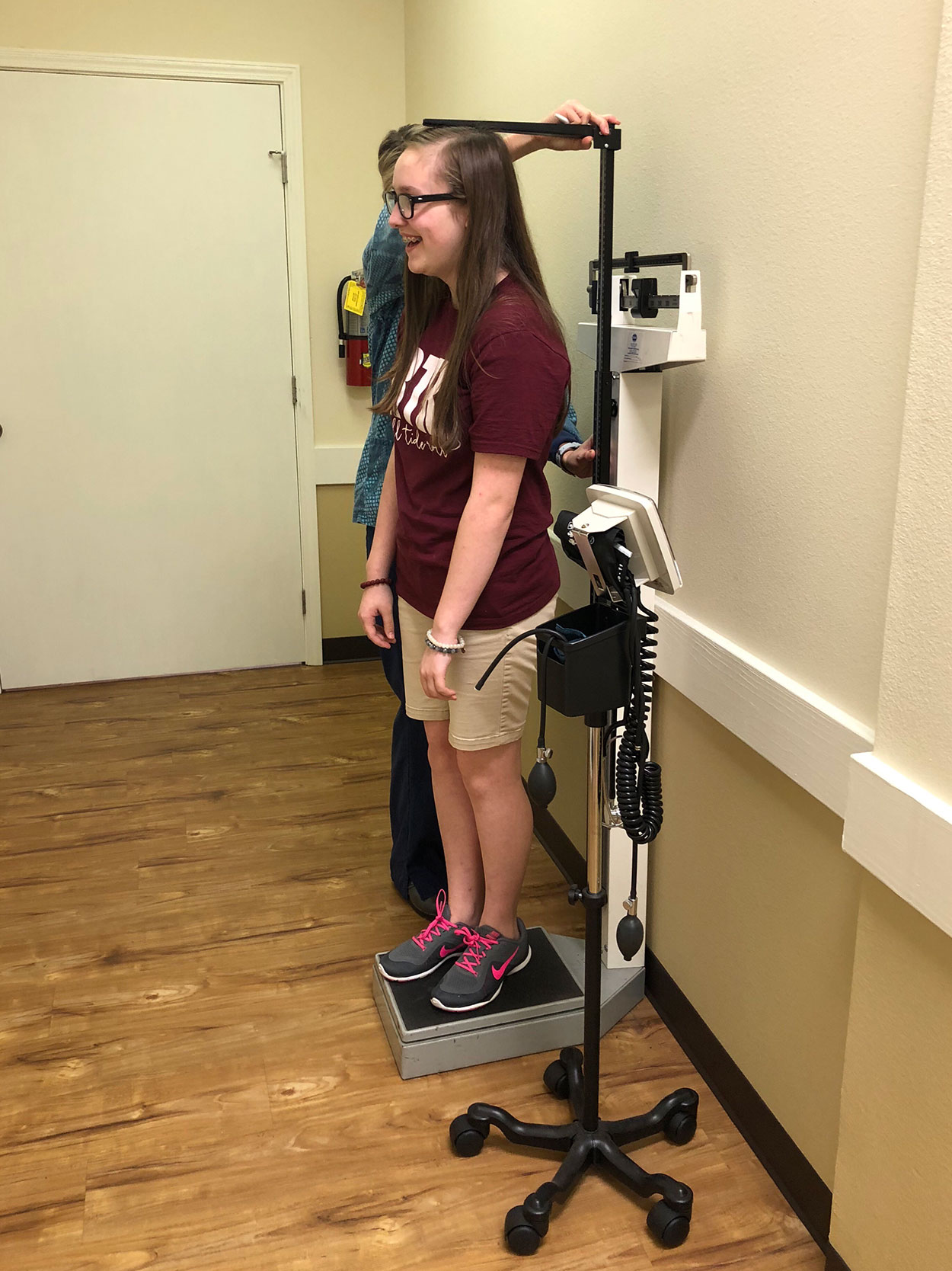 Nurse Measuring the Height of a Teenage Girl.