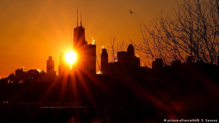 Smoke rises from the skyscrapers during sunrise as extremely cold weather reaching minus 20 in the nights hits Chicago